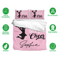 Pink cheerleading bedding set displayed with matching pillowcases and soft, breathable, machine-washable fabric icons