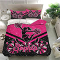 Pink cheerleading duvet cover set displayed in a lively bedroom with megaphones and pom pom graphics