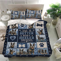 Australian Cattle Dog bedding set on a bed with blue patchwork panels, paw prints, bones, and heeler portraits