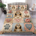 Shih Tzu duvet cover set displayed on a bed with floral patchwork, paw prints, hearts, bones, and crowns