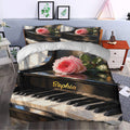 Piano duvet cover bedding set styled in a bedroom with pink roses, black keys, and matching pillows