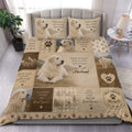 Great Pyrenees duvet cover set displayed on a bed with realistic dog portraits, paw prints, mountains, and warm neutral tones