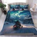 Snowmobile duvet cover set displayed on a bed with an aurora, snowy mountains, and alpine trail design