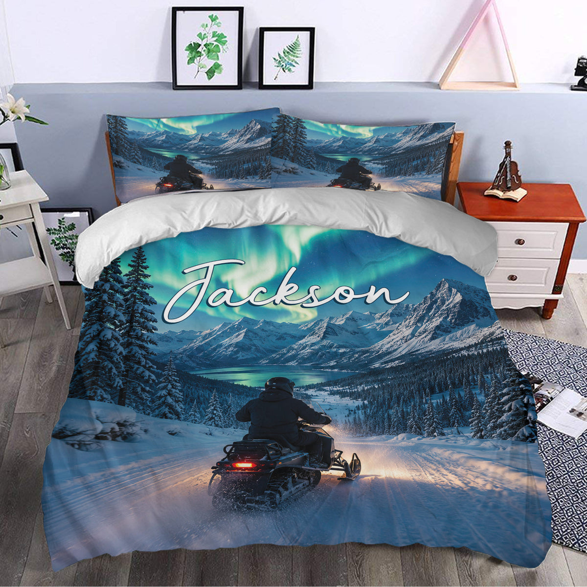 Snowmobile duvet cover styled in a bedroom with aurora skies, snowy mountains, pine trees, and trail artwork