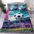 Soccer duvet cover set displayed on a bed with vivid blue, pink, and green ball and goal artwork