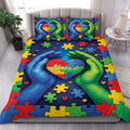 Autism duvet cover set with colorful puzzle pieces, heart design, and blue and green hands on a bedroom