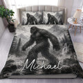Bigfoot duvet cover set displayed on a bed with grayscale mountain, forest, and waterfall artwork