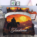 Cowboy duvet cover styled in a bedroom with a sunset mountain landscape, rider, horse, and matching pillows