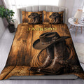 Cowboy duvet cover set displayed on a bed with western boots, cowboy hat, rope, and rustic wood design