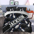 Bowling duvet cover styled in a bedroom with dark blue bowling balls, pins, and diagonal graphic lettering