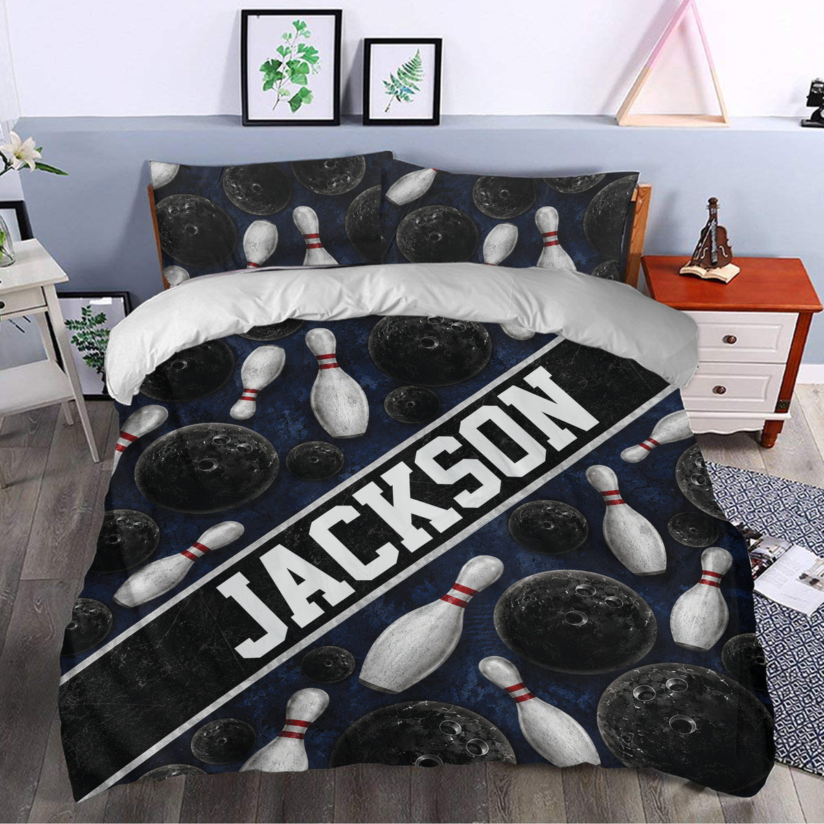 Bowling duvet cover styled in a bedroom with dark blue bowling balls, pins, and diagonal graphic lettering