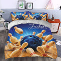 Bowling bedding displayed in a bedroom with vivid blue artwork, bowling pins, and bowling balls