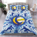 Blue and yellow volleyball duvet cover bedding set with athletic silhouettes and splash art in a bedroom