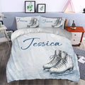 Ice skating duvet cover bedding set styled in a bedroom with pale blue snowflake artwork