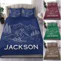 Navy skiing duvet cover set with mountain peaks, evergreen trees, and a skier on the slopes