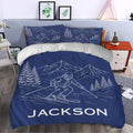 Navy skiing duvet cover set styled in a bedroom with mountain and skier artwork