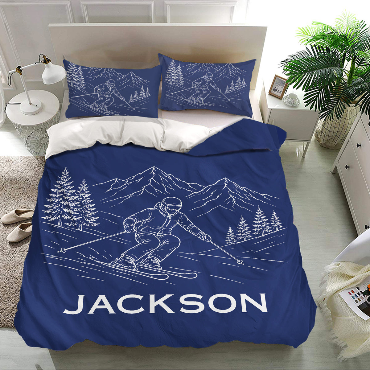 Navy skiing bedding set displayed in a modern bedroom with skier, mountain, and tree artwork