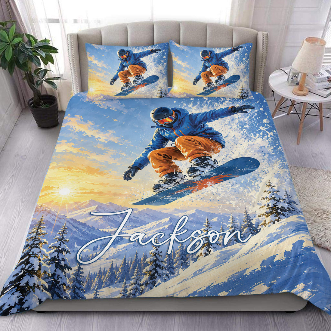 Custom name winter sports duvet cover bedding set featuring a snowboarder jumping above snowy alpine mountains at sunset, blue jacket, orange pants, flying snow, pine trees and matching snowboarder pillowcase designs.