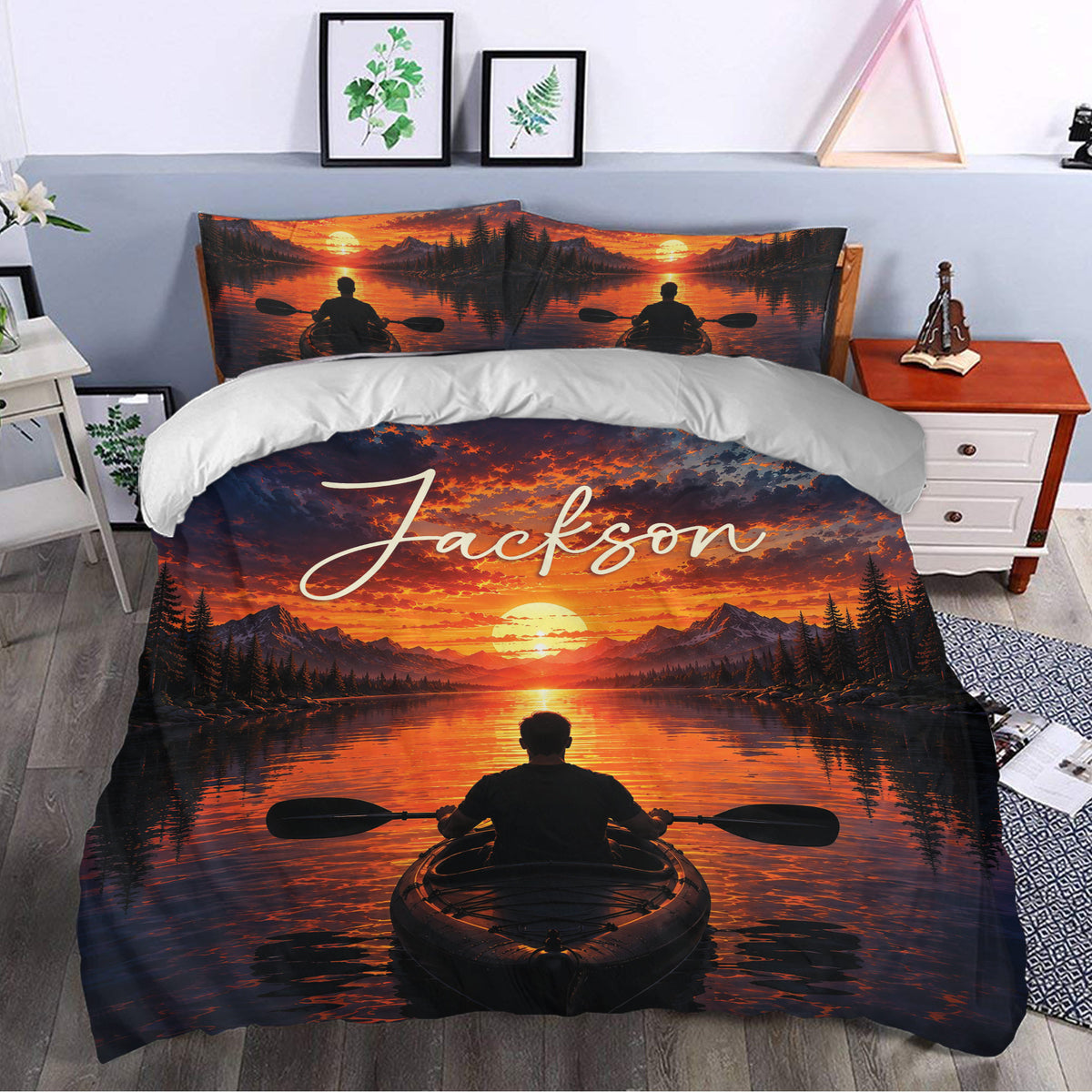 Kayak bedding set styled in a bedroom with orange sunset mountains, trees, and a paddler