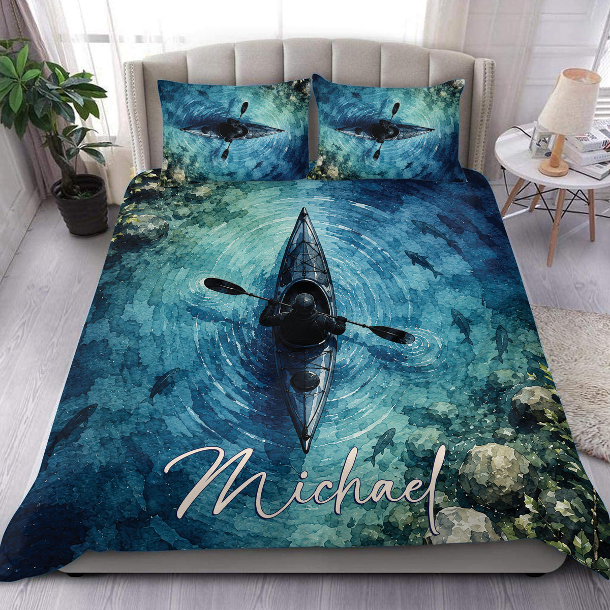 Blue watercolor kayak duvet cover set styled on a bed with matching pillows and scenic water artwork