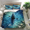 Blue kayak bedding set displayed in a bright bedroom with matching pillows and aquatic watercolor scenery
