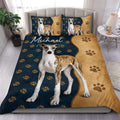 Whippet duvet cover set displayed on a bed with navy and tan paw print artwork