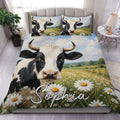 Dairy cow duvet cover set displayed on a bed with meadow, daisy field, and pastoral countryside artwork