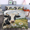 Dairy cow duvet cover styled in a bedroom with a large cow portrait, blue sky, and daisy meadow scene