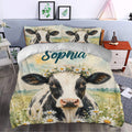 Dairy cow duvet cover bedding displayed in a bright bedroom with floral farmhouse artwork
