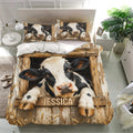 Farmhouse dairy cow duvet cover set displayed in a bright bedroom with rustic wood artwork