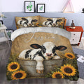 Dairy cow duvet cover bedding set styled in a bedroom with rustic calf and sunflower artwork