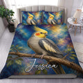 Cockatiel duvet cover set displayed on a bed with painterly blue, gold, and teal bird artwork