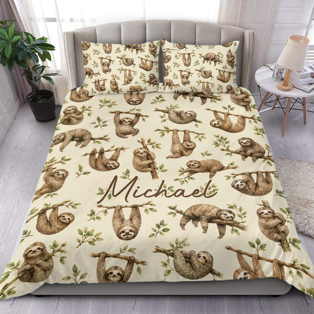 Sloth duvet cover set displayed on a modern bed with leafy branches and a warm cream background