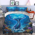 Mermaid duvet cover bedding set styled in a bedroom with a large shimmering tail and coral reef scene