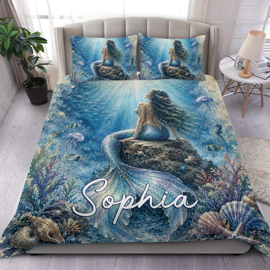 Blue mermaid duvet cover set displayed on a bed with underwater coral, fish, shells, and sea life