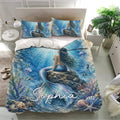 Ocean-themed mermaid bedding set presented in a bright bedroom with matching blue pillowcases and coral artwork