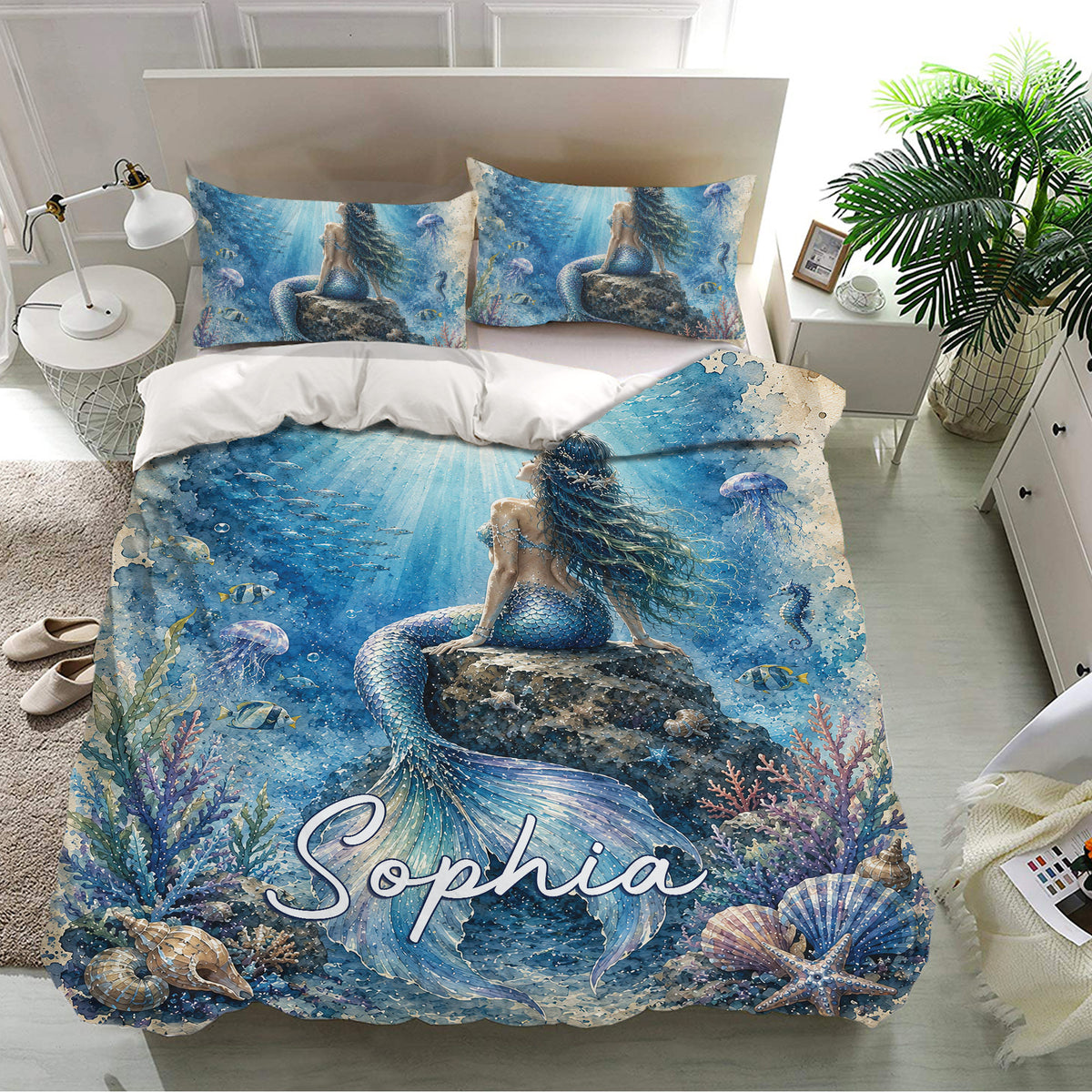 Ocean-themed mermaid bedding set presented in a bright bedroom with matching blue pillowcases and coral artwork
