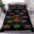 Colorful dragonfly duvet cover set displayed on a modern bed with matching black pillowcases