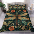 Dragonfly duvet cover set displayed on a bed with ornate floral vines in deep green, teal, copper, and gold