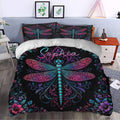 Dragonfly duvet cover bedding set styled in a bedroom with bold black, pink, purple, and turquoise artwork