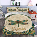Dragonfly duvet cover bedding displayed in a bright bedroom with cream, teal, green, and gold decorative artwork