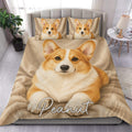 Corgi duvet cover set displayed on a bed with warm tan artwork and matching dog portrait pillowcases