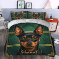 Miniature Pinscher duvet cover styled in a bedroom with a bold dog portrait, green background, and gold border