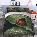 Ladybug duvet cover bedding styled in a bedroom with botanical green leaves and vivid red insect artwork