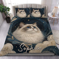 Ragdoll cat duvet cover set styled on a bed with blue, gold, starry artwork and matching pillowcases