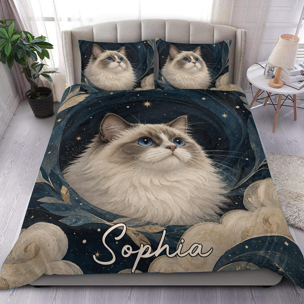 Ragdoll cat duvet cover set styled on a bed with blue, gold, starry artwork and matching pillowcases