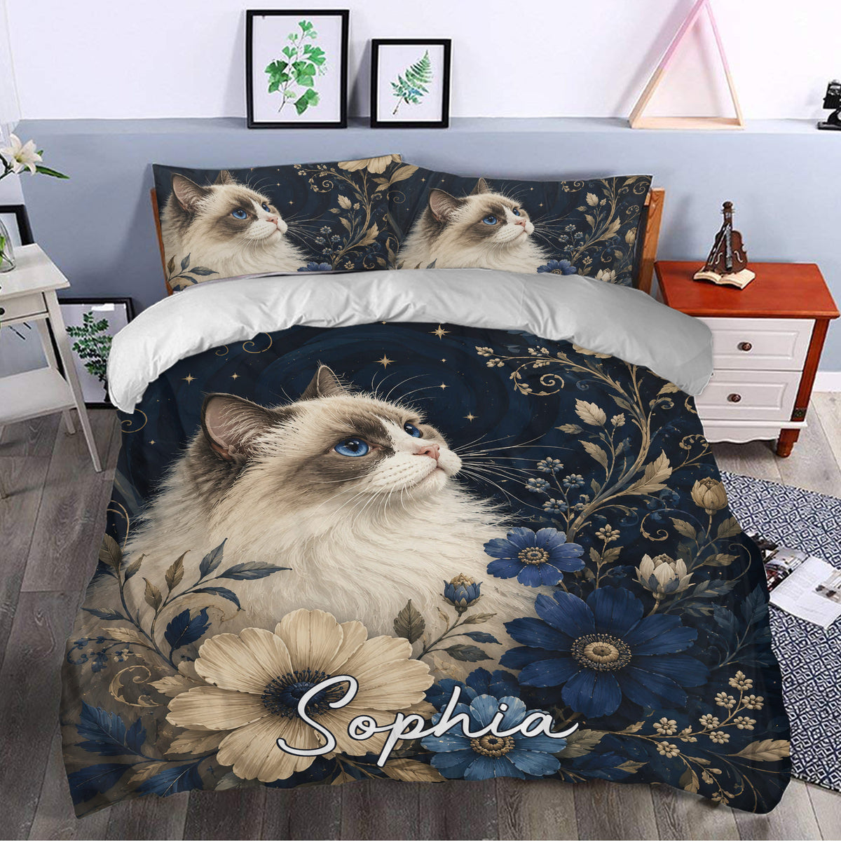 Ragdoll cat bedding styled in a bedroom with blue floral artwork and a large illustrated cat