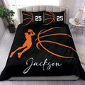 Black and orange basketball duvet cover set styled on a bedroom bed with a shooting player silhouette