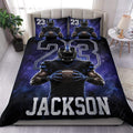 Football duvet cover set displayed on a bed with a helmeted player, deep blue artwork, and bold jersey-style graphics