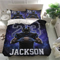 Football bedding set in a modern bedroom featuring a helmeted player, football artwork, and dramatic blue and black colors